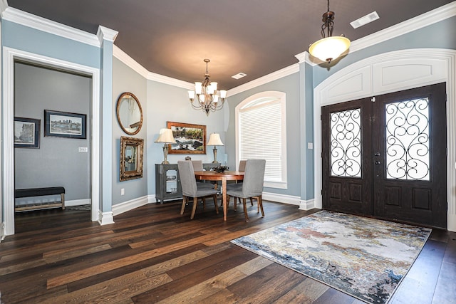 entrance foyer featuring visible vents, ornamental molding, french doors, an inviting chandelier, and dark wood-style flooring