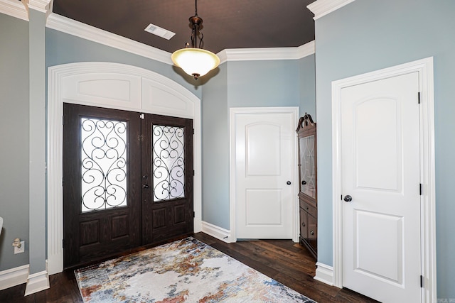 foyer entrance with visible vents, baseboards, dark wood finished floors, ornamental molding, and french doors