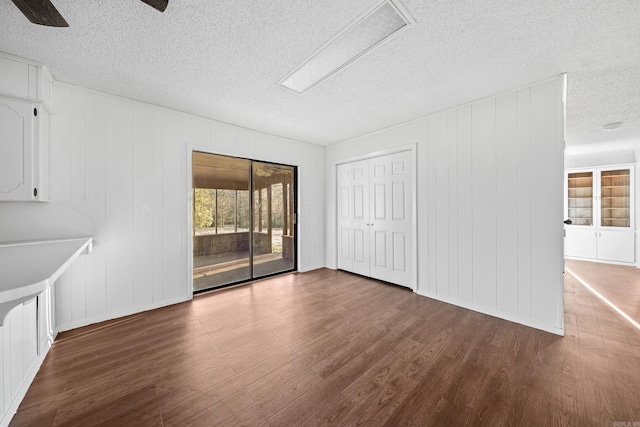 spare room featuring a textured ceiling and wood finished floors