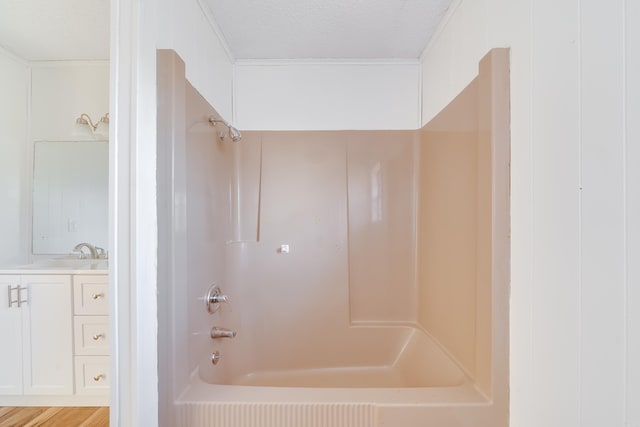 full bath featuring shower / washtub combination, a textured ceiling, and vanity