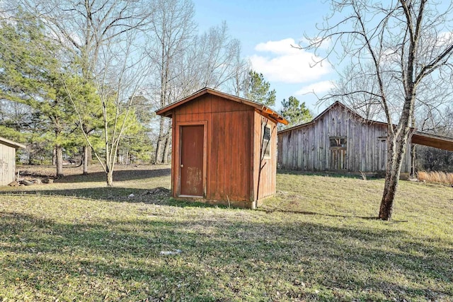 view of barn with a lawn and a shed