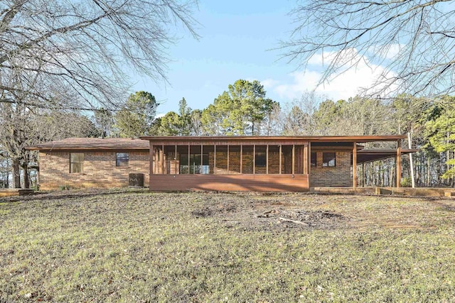 back of property with brick siding and central AC unit