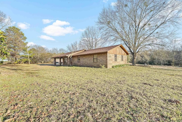 view of property exterior with a yard and brick siding