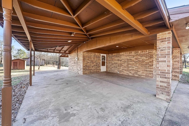 view of patio featuring a storage shed and an outdoor structure