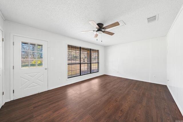 unfurnished room featuring a textured ceiling, visible vents, dark wood-style flooring, and ceiling fan