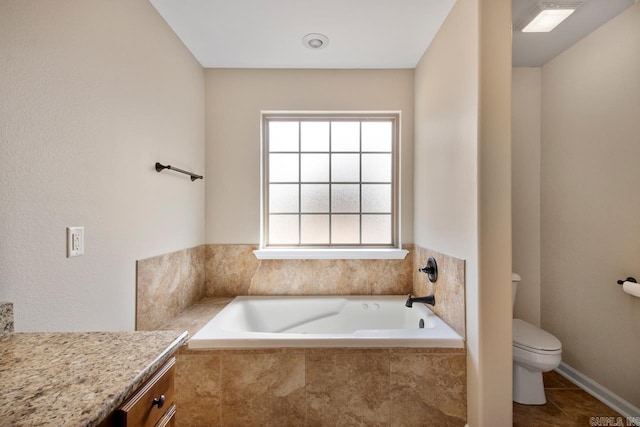 full bath featuring a garden tub, toilet, vanity, and tile patterned flooring