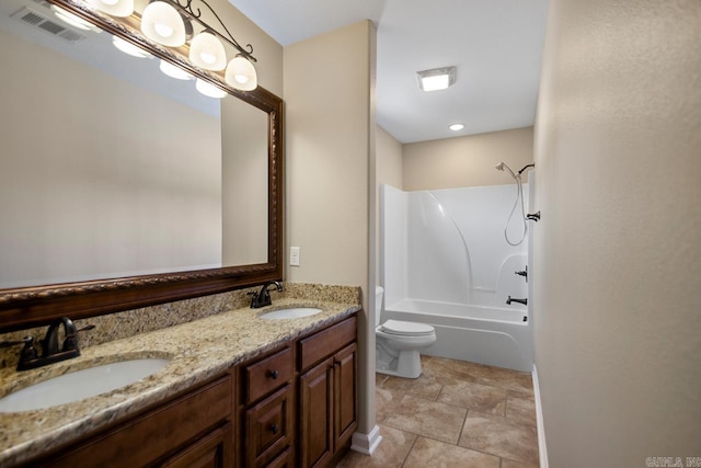 bathroom featuring double vanity, visible vents, toilet, and a sink