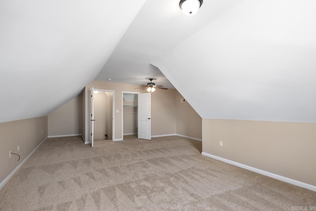 bonus room featuring baseboards, carpet floors, and vaulted ceiling