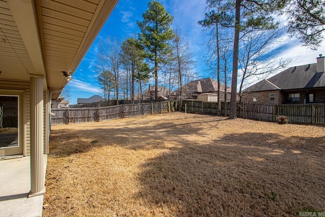 view of yard with a residential view and a fenced backyard