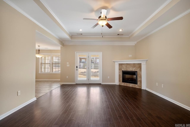 unfurnished living room with a fireplace, dark wood-type flooring, baseboards, and ornamental molding