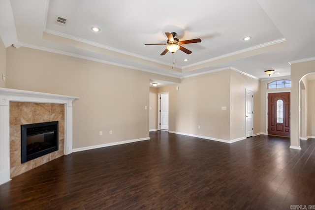 unfurnished living room with a fireplace, baseboards, visible vents, and dark wood-style flooring