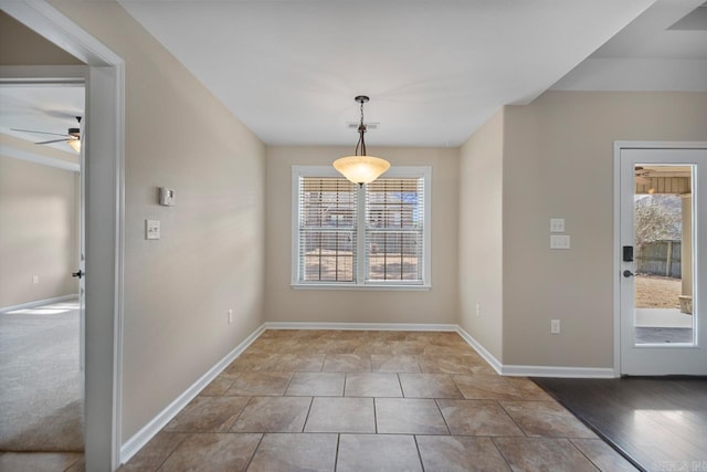 unfurnished dining area with visible vents and baseboards