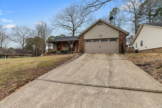 single story home featuring a porch, an attached garage, concrete driveway, central air condition unit, and brick siding