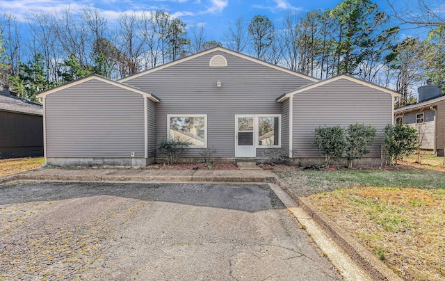 view of front of house featuring crawl space and uncovered parking