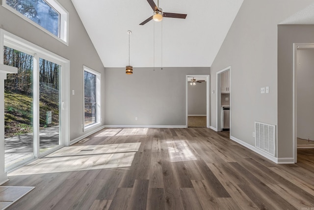 interior space featuring visible vents, wood finished floors, high vaulted ceiling, and ceiling fan