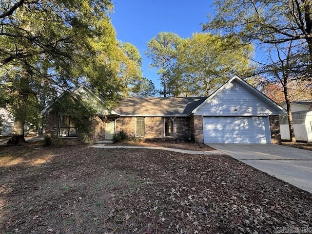 view of front of house with concrete driveway and an attached garage