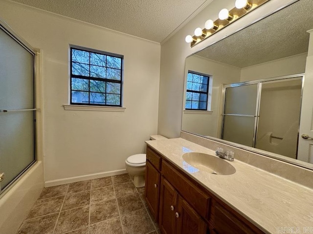 bathroom with baseboards, toilet, vanity, shower / bath combination with glass door, and a textured ceiling