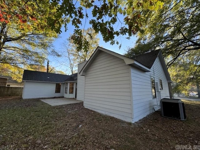 back of property with central air condition unit, a patio, and fence