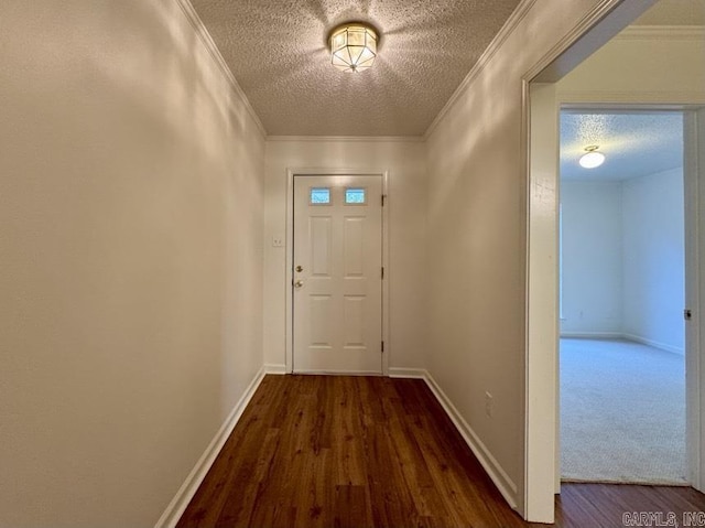 entryway featuring baseboards, wood finished floors, a textured ceiling, and ornamental molding