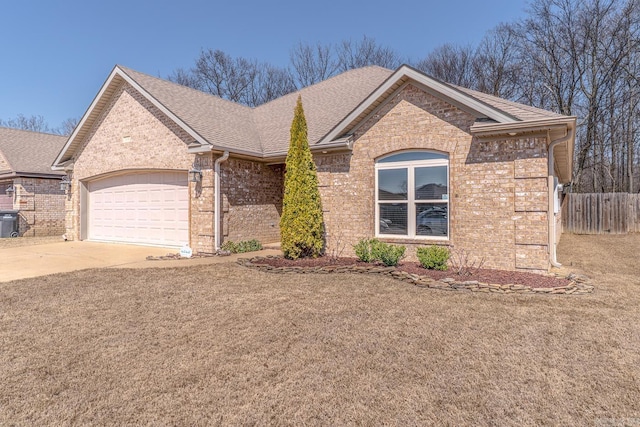 single story home with driveway, fence, roof with shingles, a garage, and brick siding