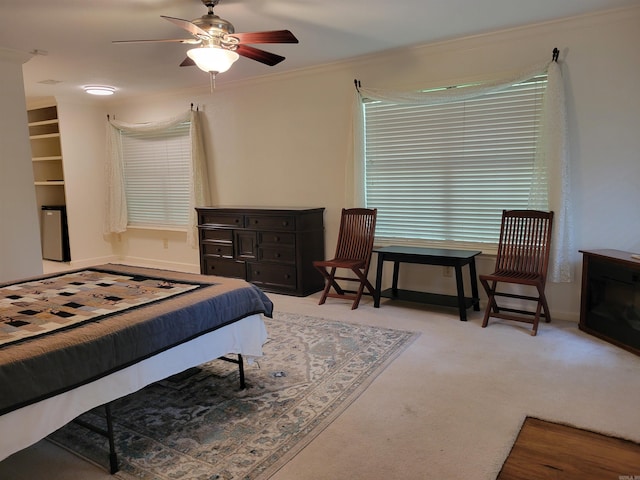 bedroom with crown molding, carpet flooring, baseboards, and ceiling fan