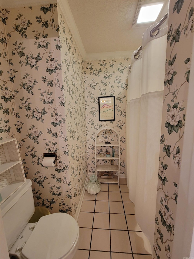 bathroom featuring toilet, wallpapered walls, a textured ceiling, crown molding, and tile patterned flooring