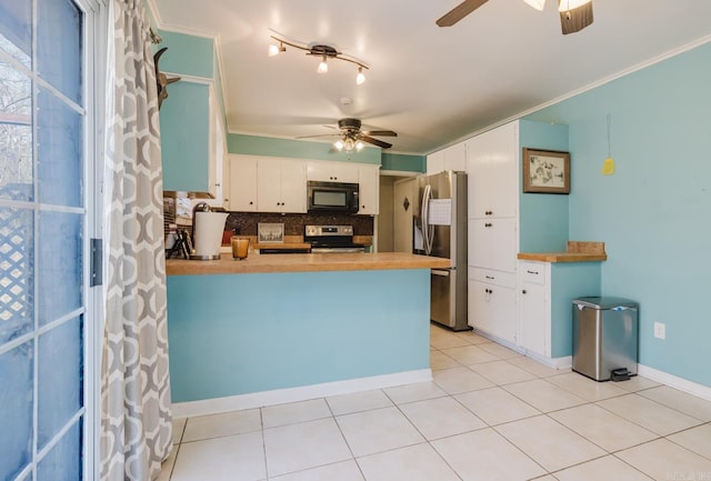 kitchen featuring white cabinetry, appliances with stainless steel finishes, a peninsula, light tile patterned floors, and decorative backsplash