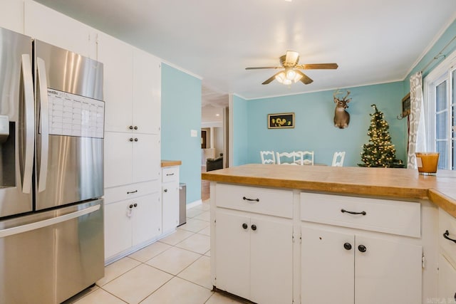 kitchen featuring light countertops, white cabinets, light tile patterned floors, and stainless steel fridge with ice dispenser