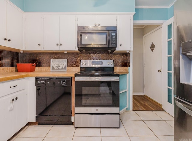 kitchen featuring light tile patterned floors, black appliances, white cabinets, light countertops, and backsplash