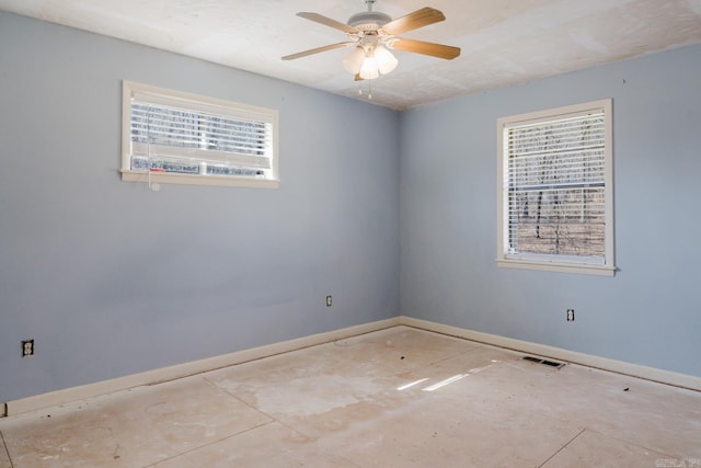 spare room featuring visible vents, baseboards, and a ceiling fan