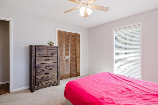 bedroom featuring carpet flooring, baseboards, a closet, and ceiling fan