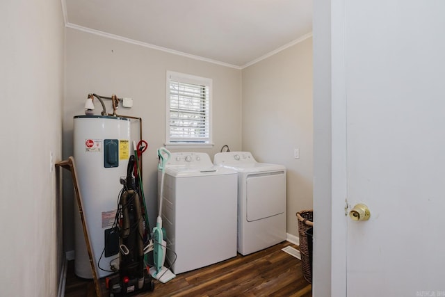 laundry area with electric water heater, dark wood-type flooring, ornamental molding, laundry area, and separate washer and dryer