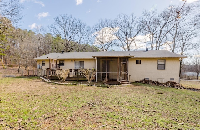 back of house with a wooden deck, a yard, a sunroom, crawl space, and brick siding