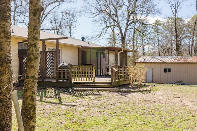 back of house featuring a wooden deck and brick siding