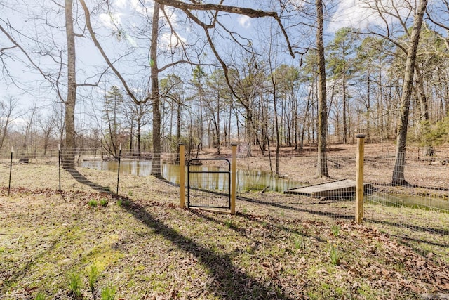 view of yard featuring a water view and fence