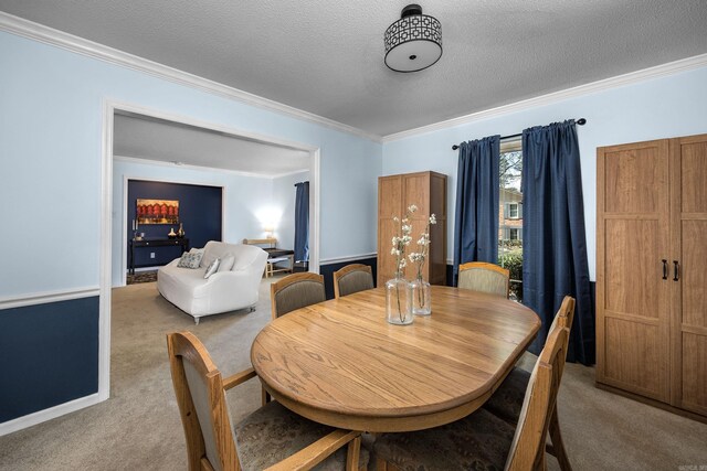 dining area with carpet flooring, a textured ceiling, and ornamental molding