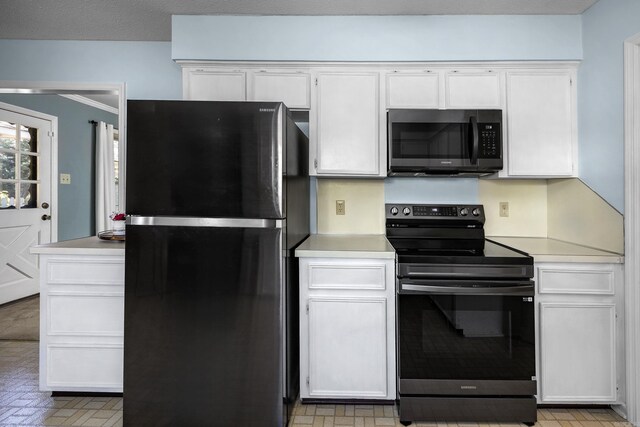 kitchen featuring white cabinetry, black appliances, and light countertops