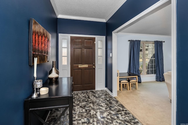 carpeted entryway with a textured ceiling and crown molding