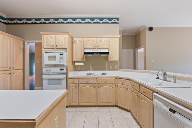 kitchen with white appliances, light brown cabinetry, under cabinet range hood, and a sink