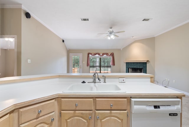 kitchen featuring visible vents, light brown cabinetry, light countertops, white dishwasher, and a sink