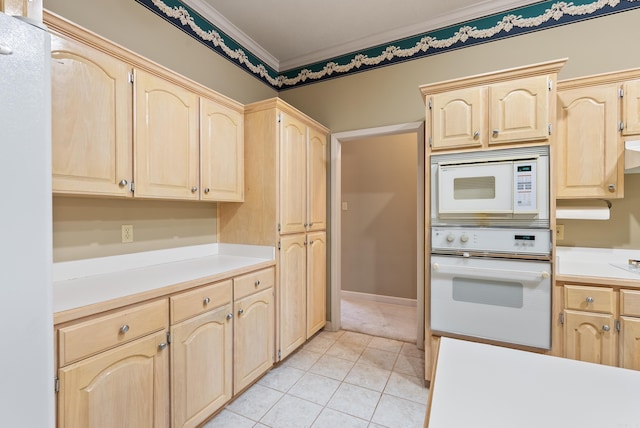 kitchen with ornamental molding, light brown cabinetry, white appliances, light countertops, and light tile patterned floors