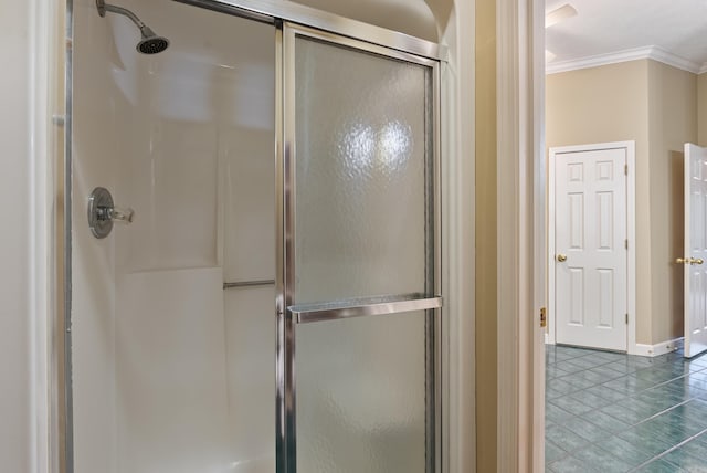 bathroom featuring baseboards, a stall shower, tile patterned flooring, and ornamental molding