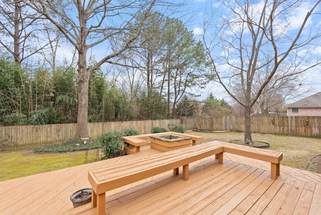 deck with a yard, an outdoor fire pit, and a fenced backyard