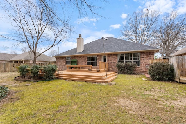 back of property featuring brick siding, a lawn, and fence private yard