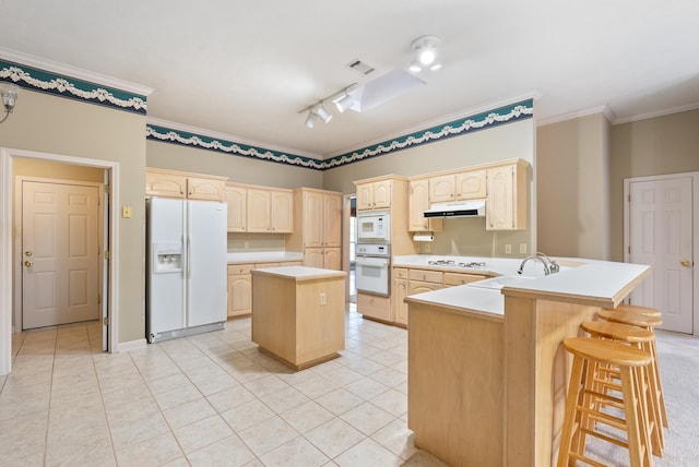 kitchen with visible vents, light brown cabinetry, ornamental molding, a peninsula, and white appliances