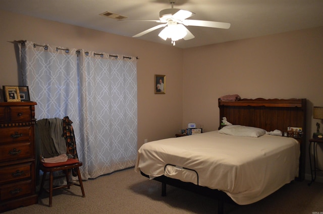 bedroom featuring a ceiling fan, visible vents, and carpet floors