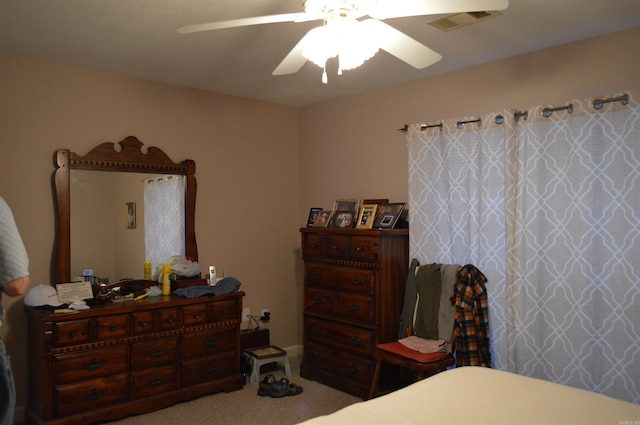 carpeted bedroom featuring visible vents and ceiling fan