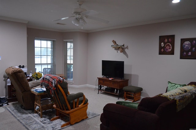 living area with light colored carpet, a ceiling fan, baseboards, and ornamental molding