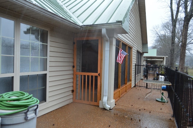 doorway to property featuring a balcony, metal roof, and a standing seam roof