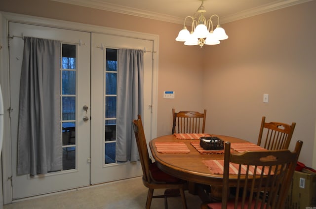 dining area featuring french doors, crown molding, and an inviting chandelier